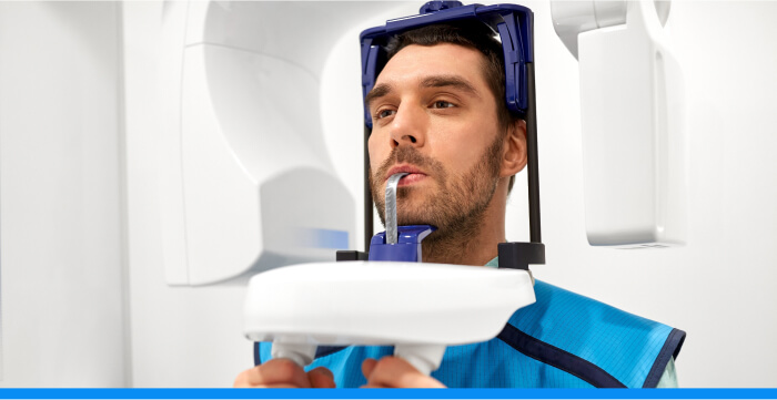 A man with his head in a CBCT scanner